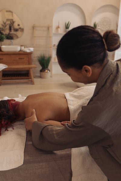 Masseuse Massaging Woman's Arm